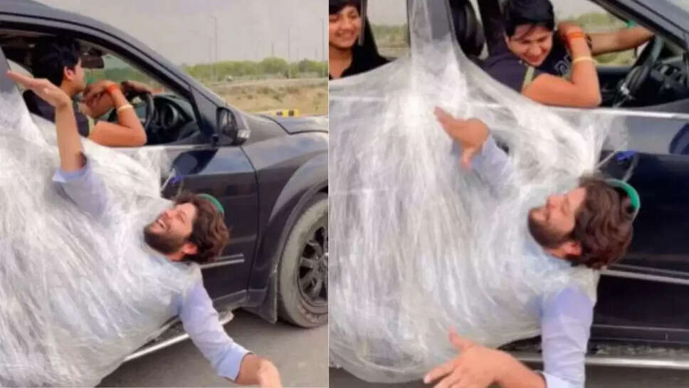 காரில் தொங்கும் இளைஞர்  