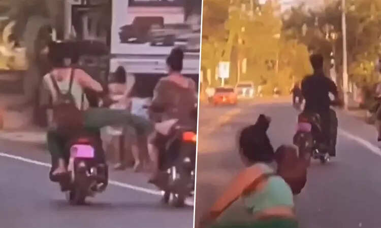 பைக்கில் சென்றவரை ஓங்கி உதைத்த பெண்!! தலைக்குப்புற விழுந்த விபரீதம்!!